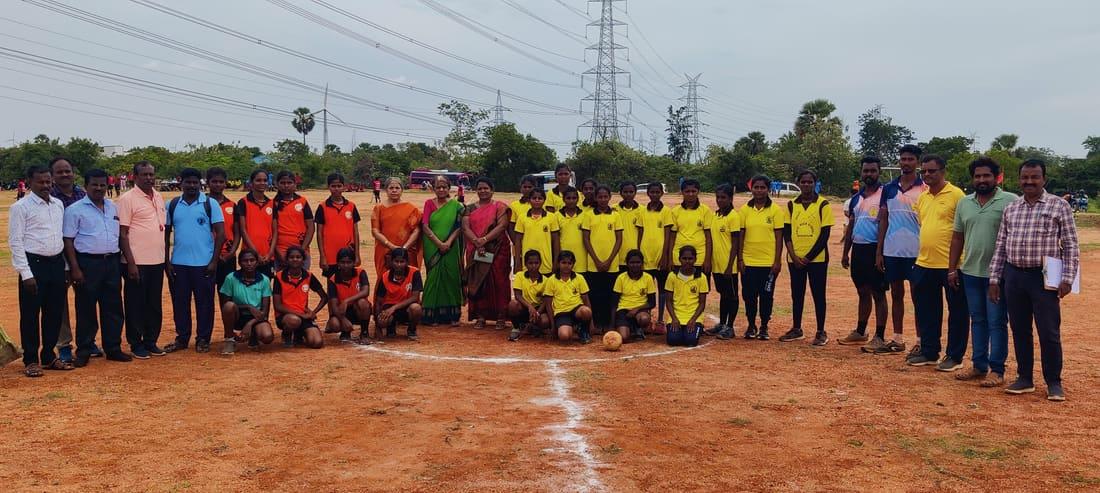 Girls and coaches together on the sports ground